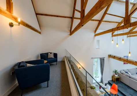 Bedroom #1 mezzanine sitting areaat Little Marland Barn, Petrockstowe
