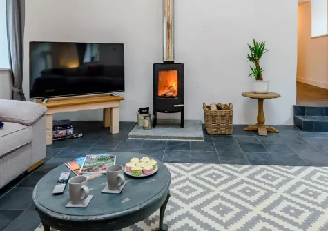 Little Marland Barn, Petrockstowe is a spectacular six-bedroom converted barn with countryside views, private hot tub, & games room. Featuring luxurious interiors, exposed beams, and an ideal location for discovering Devon & Cornwall's treasures.
