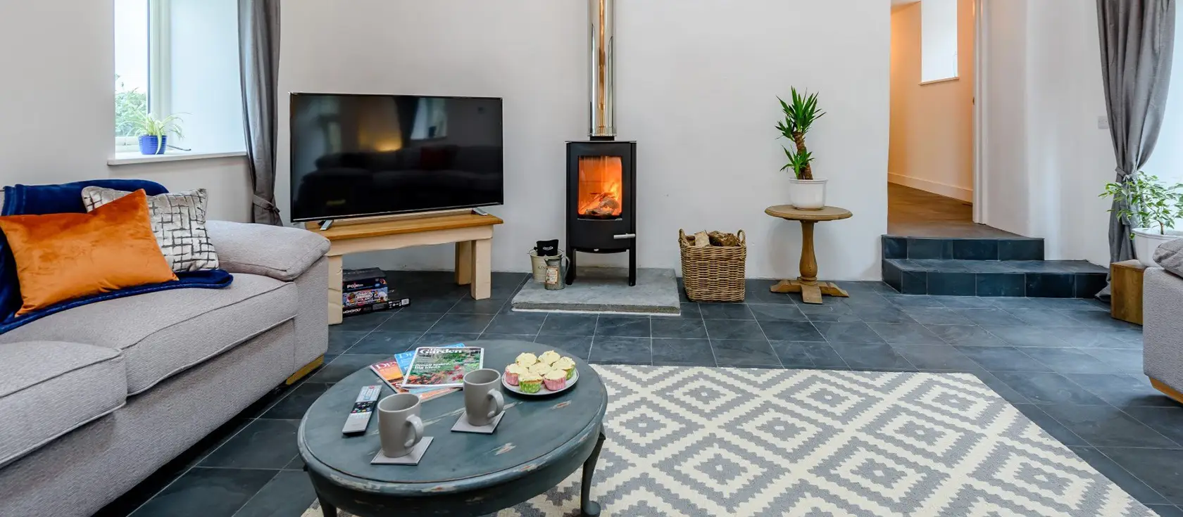 Little Marland Barn, Petrockstowe is a spectacular six-bedroom converted barn with countryside views, private hot tub, & games room. Featuring luxurious interiors, exposed beams, and an ideal location for discovering Devon & Cornwall's treasures.