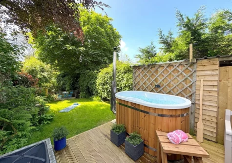 The decked  patio, wood-fired Japanese hot tub & garden at Little Merryfield, Guineaford