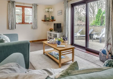 Little Wagtail, Chilla, is a charming two-bedroom cottage with stunning countryside views, enclosed wrap-around decking, and shared games room. Explore Devon's attractions, historic castles, and beautiful coastline from this peaceful rural retreat.
