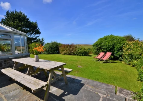 The patio, alfresco dining area & garden at Long Cottage, Trelights