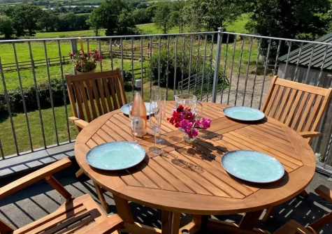The balcony & alfresco dining area at Lower Chasty Barn, Holsworthy