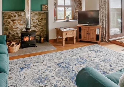 Lower Chasty Barn, Holsworthy is a stunning barn conversion set in peaceful Devon countryside, featuring original beams, contemporary interiors, a warming wood burner, private balcony with rural views, and secure paddock for dogs to roam freely.