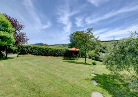 The elevated lawn garden, with hillside views, at Lower Dean Farm, Parracombe
