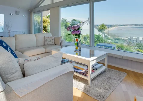 Lower Trenarthan, Penzance offers breathtaking Mount's Bay views from a stylish reverse-level house. Enjoy modern luxury, magnificent wraparound balcony, and endless coastal adventures. Perfect for memorable family getaways and romantic escapes.
