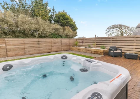 The decked patio, outdoor sitting area hot tub & enclosed garden at Lukes Barn, Mawla