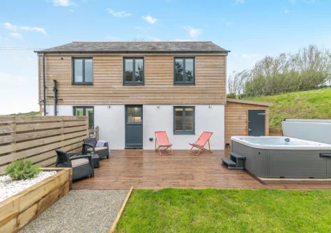The decked patio, outdoor sitting area hot tub & enclosed garden at Lukes Barn, Mawla