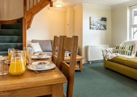Lundy, Croyde is a beautifully furnished two-bedroom apartment positioned just metres from Croyde Bay's golden sands, featuring stunning sea views, direct beach access, and flexible sleeping arrangements, perfect for couples or small families.