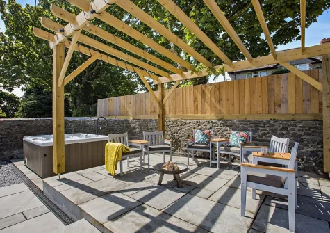 The patio, outdoor sitting area & hot tub at Lutsford Farm Barn, Bursdon
