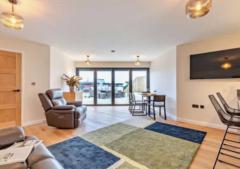 Lyndhurst, Woolacombe is a stylish one-bedroom apartment offering a romantic coastal escape for couples and their dogs, with sweeping sea views, a charming patio with BBQ, and Woolacombe's golden sands and coastal path just moments away.