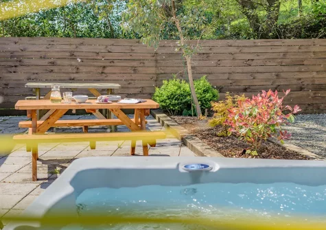The patio, alfresco dining area & hot tub at Magnolia, Bush
