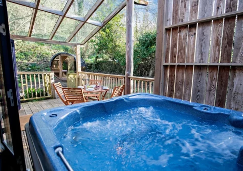 The glass-covered enclosed terrace, alfresco dining area & hot tub at Margot at Rosehill Lodges, Porthtowan