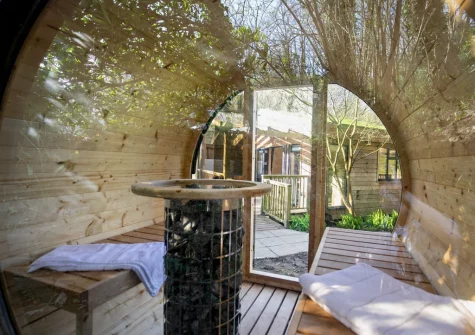 The Unwind in the private sauna, overlooking a lush woodland area, at Margot at Rosehill Lodges, Porthtowan at Margot at Rosehill Lodges, Porthtowan