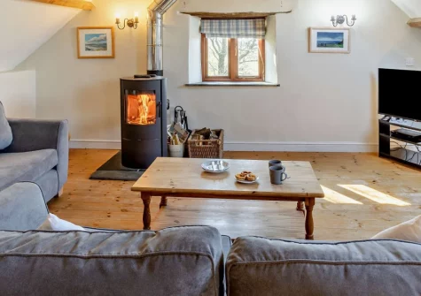 Marsland Cottage at Cory Farm, Gooseham is a spacious converted granary set within 267 acres of organic farmland, offering stunning sea views, traditional features, a private garden, and an all-weather play barn for memorable family escapes.