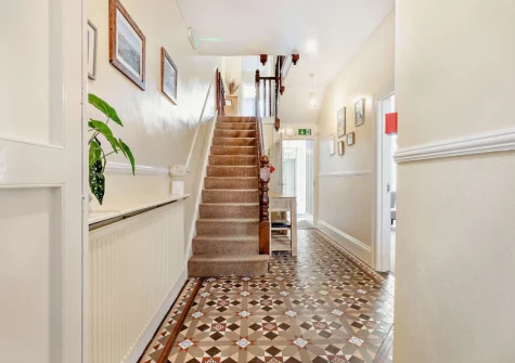 The entrance hallway & stairs up to the first floor at Mayfield, Ilfracombe