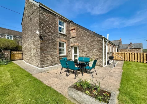 The patio, alfresco dining area & enclosed lawned garden at Meadow Cottage at Cannalidgey Farm, St Issey