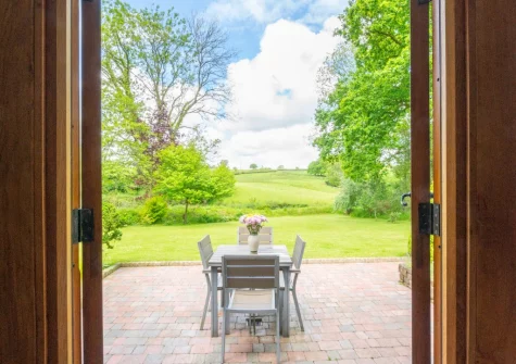 Step out onto the patio & alfresco dining area at Meadowside Barn, Meshaw