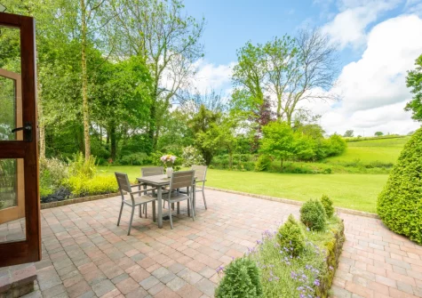 The patio, alfresco dining area & large garden at Meadowside Barn, Meshaw
