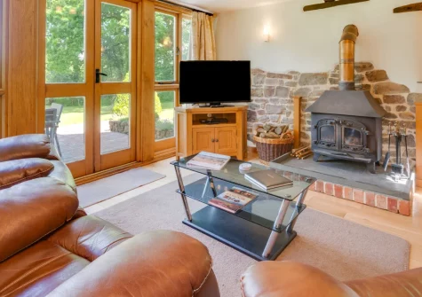 Meadowside Barn, Meshaw is a stunning two-bedroom barn conversion in rural Devon with vaulted ceilings, exposed beams, a wood burner, and a large mature garden. It's a wonderful retreat for families and couples seeking peaceful countryside.