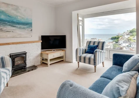 Meadowsweet, Looe is a charming hillside cottage with commanding river and sea views. Enjoy elevated decks, a fully enclosed garden, and direct access to Looe's harbour, beaches, and shops—perfect for families seeking a Cornish escape.