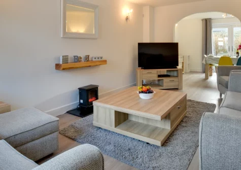 Mena-Gwins, Padstow is a spacious four-bedroom house perched above the historic harbour, featuring a sunny patio garden with barbecue, modern interiors with flexible living spaces, and a great position for exploring Cornwall's culinary capital.