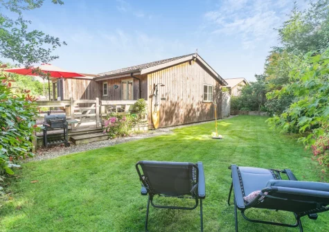 The decked terrace, babrbecue & enclosed lawned garden at Merlin Lodge, Winnard's Perch