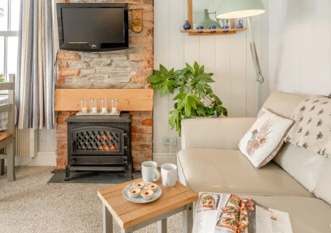 Merlins Roost, Tintagel is a beautifully refurbished one-bedroom apartment with spectacular views of the legendary Tintagel Castle, featuring a private balcony, cosy fire, and direct access to the South West Coast Path and stunning Cornish beaches.