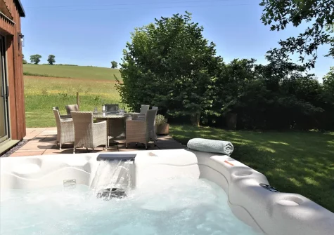 The hot tub, alfresco dining area & garden at Merry Barn, Payhembury
