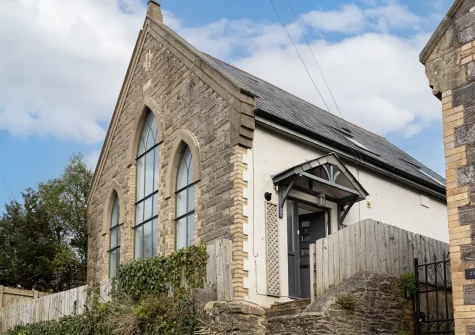 Midholm Chapel is a beautiful old stone building with distinctive architectural features that nod to its former purpose as a church