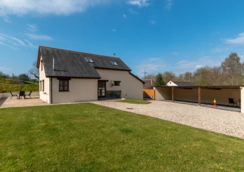 The patio, alfresco dining area & enclosed lawned garden at Mill Barn, Bish Mill