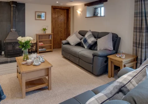 Mill Barn, Bish Mill is a beautifully converted barn on the edge of Exmoor National Park, featuring spacious interiors with wood burner, an expansive enclosed garden with patio dining area, and countryside walks directly from the door.