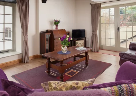 Mill Cottage, Torquay is a beautifully restored thatched mill in picturesque Cockington Village, featuring characterful beamed interiors, peaceful river views from an enclosed patio, and easy access to the English Riviera's beaches and attractions.