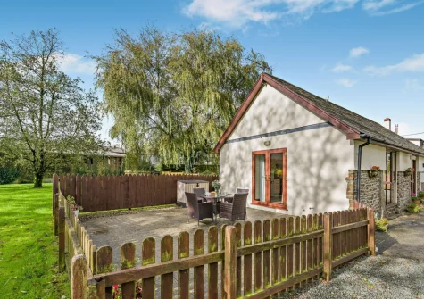 The enclosed patio, alfresco dining area & lawned garden at Millpond Stables, Clawton