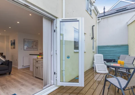 The enclosed decked patio & outdoor sitting area at Millrock Cottage, Woolacombe
