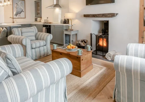 Mole End, Fowey is a charming dog-friendly stone cottage nestled near the historic Town Quay, featuring a cosy wood burner, characterful fireplaces in both bedrooms, and a private terrace, perfectly placed for exploring this vibrant harbour town.