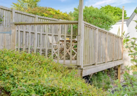 The terraced garden with decked patio, barbecue & alfresco dining area at Molesworth Cottage, Egloshayle