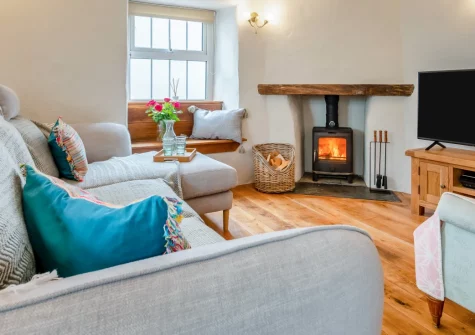 Molesworth Cottage, Egloshayle is a characterful three-bedroom retreat blending traditional beams and stonework with contemporary style, featuring a wood burner, elegant roll-top bath, sunny deck, and a friendly village pub next door.
