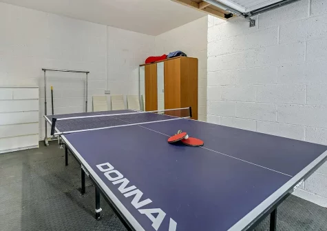 The garage has a table tennis table, wetsuit rail and a safe place to store your bikes