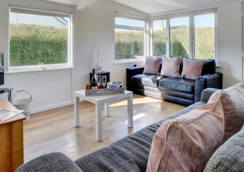 Moonraker, Croyde is a welcoming wooden chalet on the edge of this celebrated surfing village, featuring an enclosed garden perfect for families and dogs, bright open-plan living spaces, and an easy half-mile stroll to Croyde's golden sands.