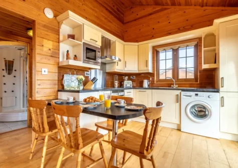 The kitchen & dining area at Moorhen Lodge 18 at Clovelly Lakes, Higher Clovelly