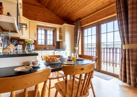 The kitchen & dining area at Moorhen Lodge 18 at Clovelly Lakes, Higher Clovelly