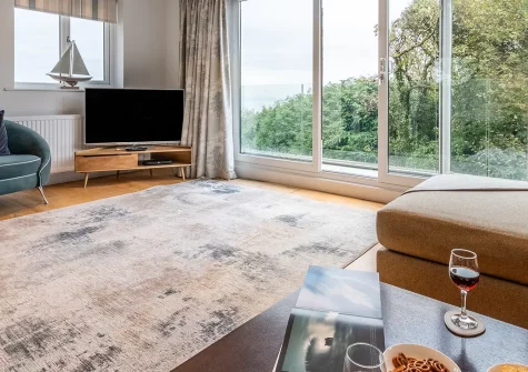 Morva, Carbis Bay is a sophisticated four-bedroom coastal escape with breathtaking sea views, a luxurious hot tub, and direct access to the South West Coast Path. Perfect for creating cherished family memories in charming Cornwall with loved ones.