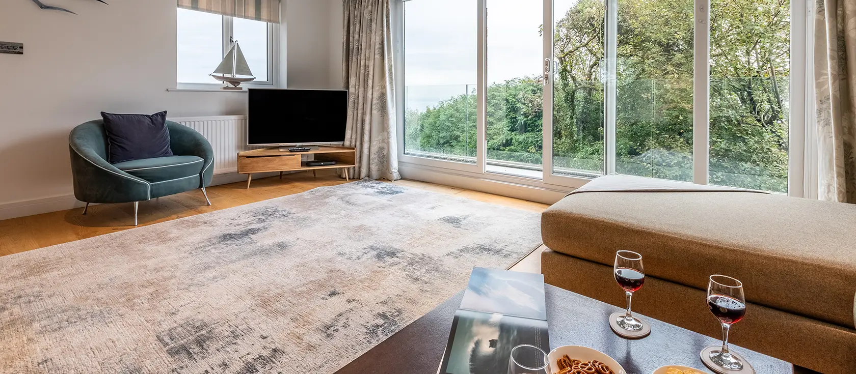 Morva, Carbis Bay is a sophisticated four-bedroom coastal escape with breathtaking sea views, a luxurious hot tub, and direct access to the South West Coast Path. Perfect for creating cherished family memories in charming Cornwall with loved ones.