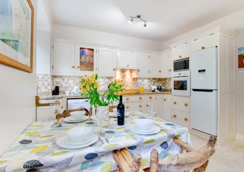 The kitchen & dining area at Morvah, 7 Zodiac House, Porthcurno