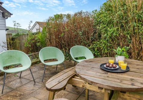 The enclosed tiered garden with patio, barbecue & alfresco dining area at Mount Rose, Woolacombe