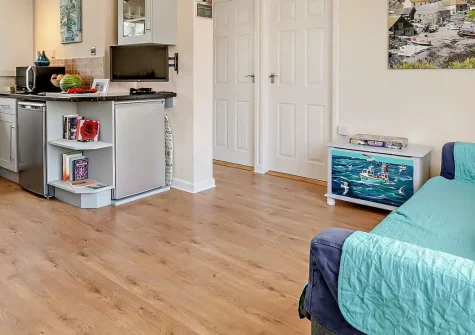 Mullion Kingfisher, Mullion Cove is a bright two-bedroom cottage set in an Area of Outstanding Natural Beauty. Enjoy dramatic coastal walks, dog-friendly beaches, and access to Cornwall's finest attractions. Perfect for unforgettable family holidays.