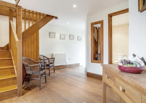 The hallway & stairs up to the first floor at Munnings Barn at Tregurnow Farm, Lamorna