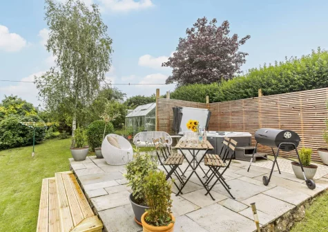 The patio, barbecue, alfresco dining, outdoor sitting area & hot tub at Mystique Cottage, Bideford