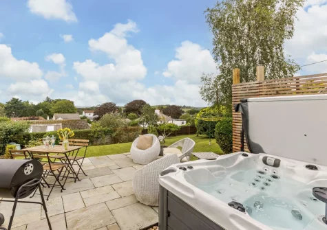 The patio, barbecue, alfresco dining, outdoor sitting area & hot tub at Mystique Cottage, Bideford